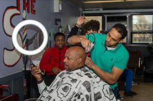 Uplift Communities barber skills workshop with a community partner